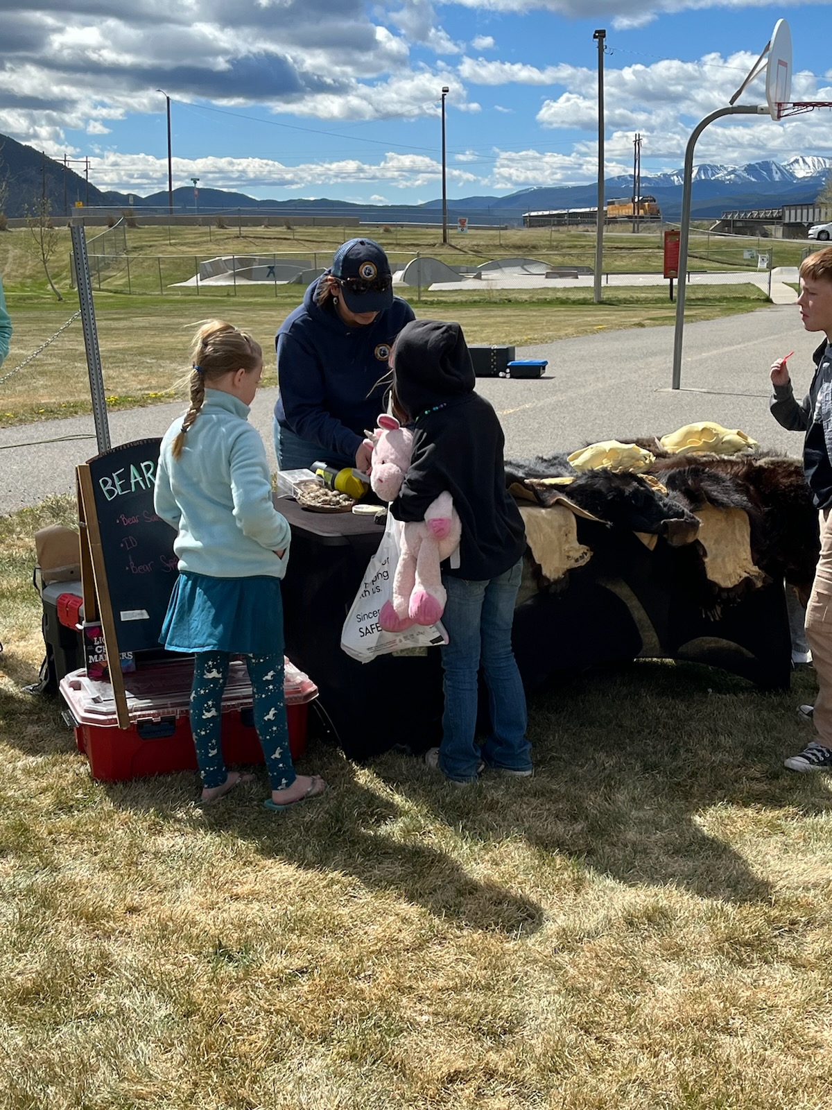 Danielle Oyler, Wildlife Stewarship Outreach Specialist for FWP, teaching kids to be "bear aware" at Outdoor Day